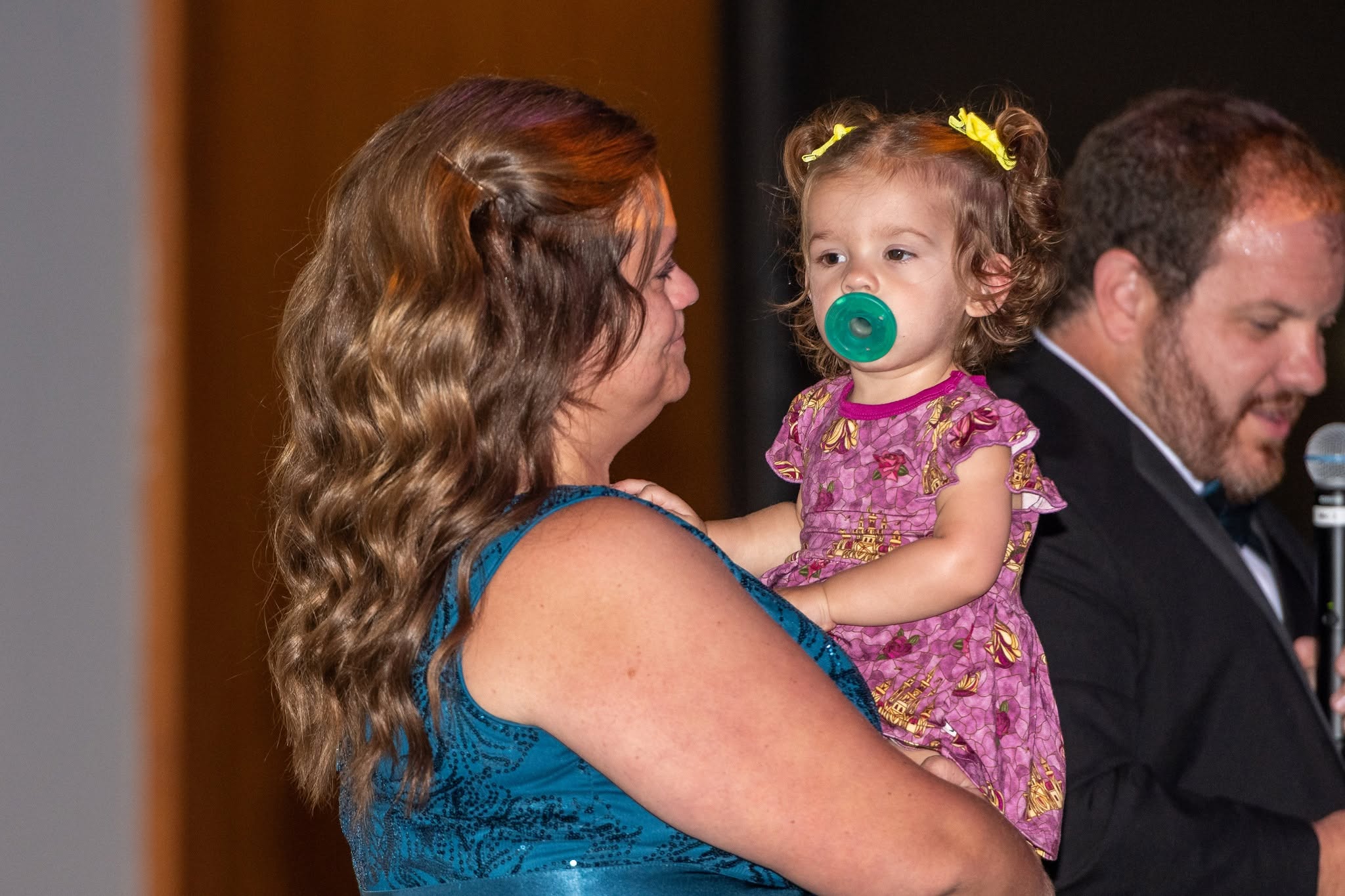 Mother and Child with Father in background attending Gala